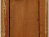 an old picture frame hanging on a wall in a room