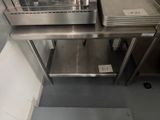 a stainless steel counter top with a bunch of trays on it