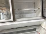 an empty refrigerator in the middle of a room