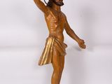 wooden statue of a man with a cross on his chest