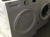 a white washer and a dryer sitting on top of each other