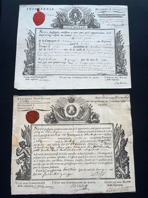 two old papers on a table with a wax seal and a wax seal
