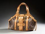 a louis vuitton handbag with a gold buckle