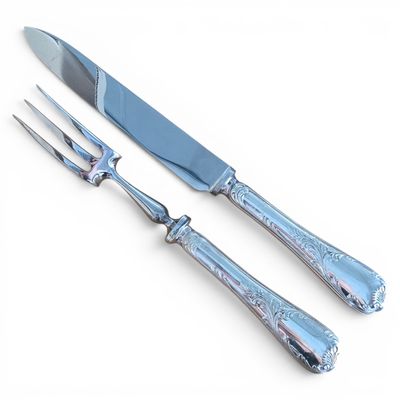 two forks and a knife on a white surface