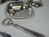 a silver plate with a spoon and spoon rest on a table
