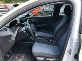 the interior of a small car with blue seats and a steering wheel