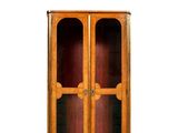a wooden cabinet with two glass doors on top of it