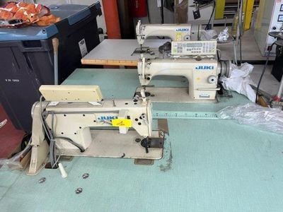 two sewing machines sitting on a table in a room
