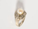 an image of a pearl and diamond ring on a white surface