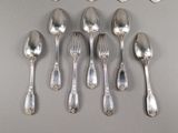 six spoons and six spoons sitting on a table