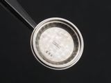 a close up of a measuring spoon with a measuring spoon in it