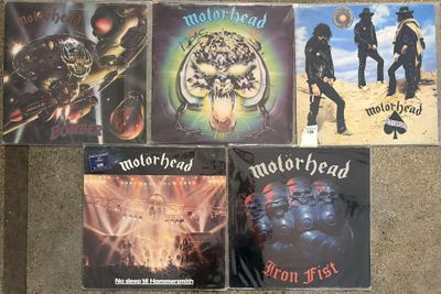 four cd ' s of motorhead on display on the floor