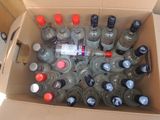 many bottles of water in a box on the floor