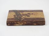 wooden box with brown and black paint on it on a white surface