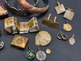 many different types of jewelry on display on a table