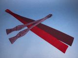 two red and black ties tied together on a blue surface