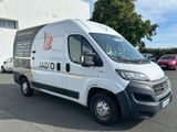 a white van parked in front of a building