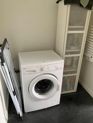 a washer and dryer in the corner of a room