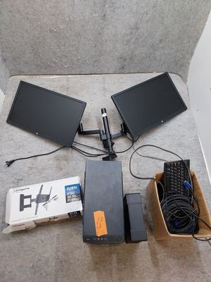 two monitors and a keyboard on the floor next to each other