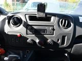 a car dashboard with a steering wheel and a cell phone holder on it