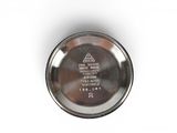a close up of a metal bowl on a white surface