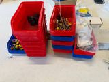 two red bins filled with assorted items on a table