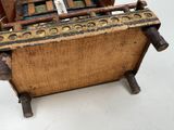 an old wooden box with some type of typewriter on top of it