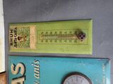 two signs on the wall that have a thermometer and a thermometer on them