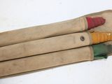four different colored pencils in a case on a table