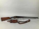 a rifle with a wooden barrel and a sling on a white background