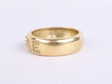 an image of a close up of a gold ring on a white surface
