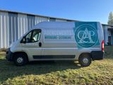 a white van parked in front of a building