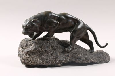 statue of a panther on a rock on a white background