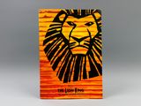 a close up of a book with a lion head on it
