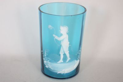 un verre bleu sur lequel est représenté un garçon