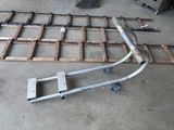 a picture of a metal bed frame with wheels and rails
