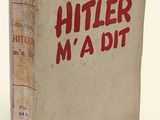 an old book with red writing on it sitting on a white surface