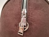 the zipper of a brown bag with a silver zipper on it
