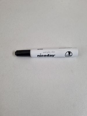 a close up of a pen on a table with a white background