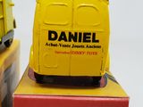 a yellow toy van sitting on top of a red box