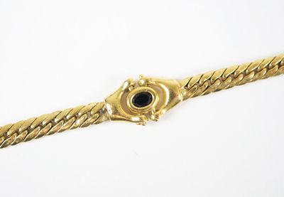 an image of a gold bracelet with a black stone in the center
