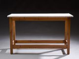 a small table with a white marble top and wooden legs
