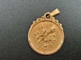 a close up of a gold medal on a black surface