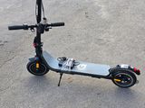 a scooter that is sitting on the ground in the parking lot