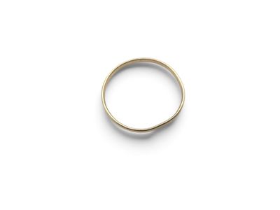 a close up of a gold ring on a white surface