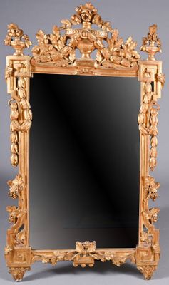 an ornately carved mirror is shown against a gray background