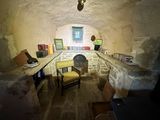an image of a room with a stone wall and a chair in it