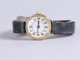 a close up of a wrist watch with roman numerals on it