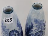 pair of blue and white vases sitting on top of a white table