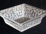 a clear glass bowl with a design on it